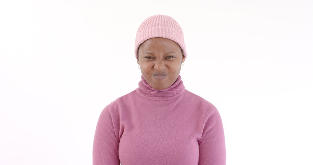 Playful Woman in Pink Sweater and Beanie Showing Expression