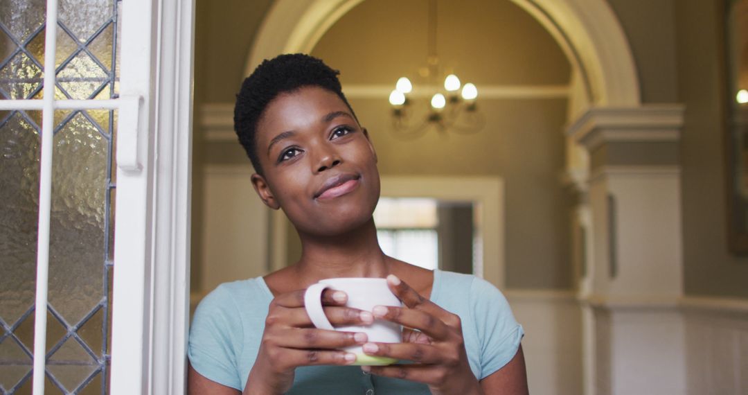 Contemplative Woman Holding Coffee Mug in Cozy Home Interior - Free Images, Stock Photos and Pictures on Pikwizard.com