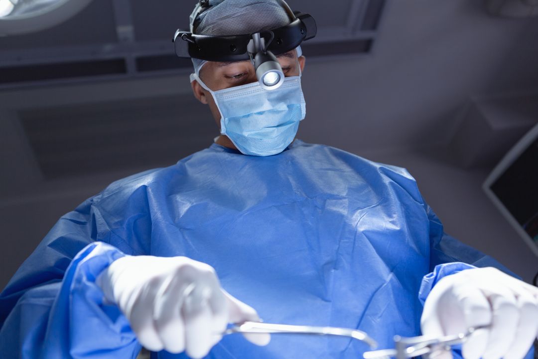Low Angle View of Surgeon Performing Surgery in Operating Room - Free Images, Stock Photos and Pictures on Pikwizard.com