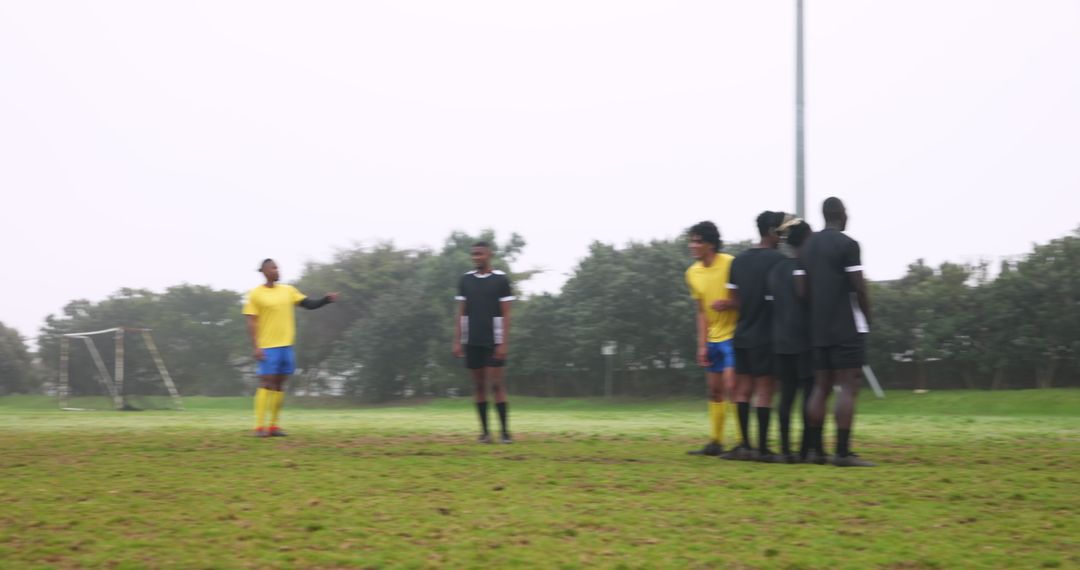 Soccer Players Preparing Free Kick in Intense Match