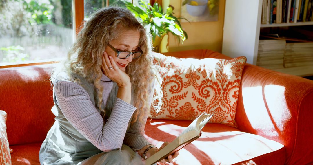 Older Woman Reading a Book in Cozy Home Setting - Free Images, Stock Photos and Pictures on Pikwizard.com