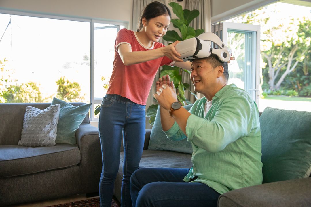 Asian Father and Daughter Enjoying Virtual Reality Adventure