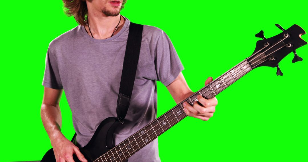 Man Playing Bass Guitar Against Green Screen - Free Images, Stock Photos and Pictures on Pikwizard.com