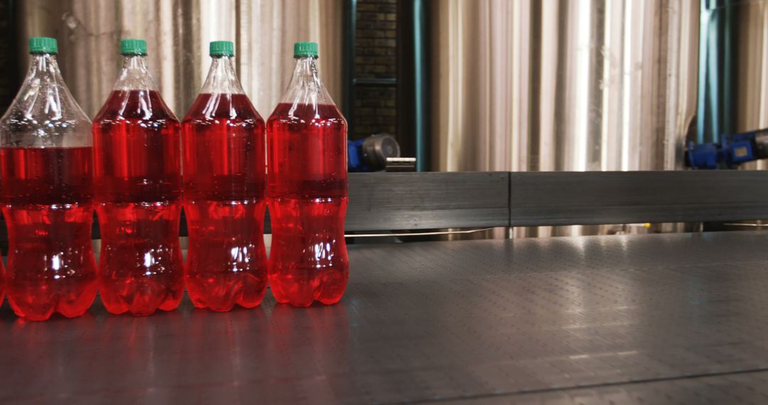 Bottled Red Soda on Production Conveyor Belt - Free Images, Stock Photos and Pictures on Pikwizard.com