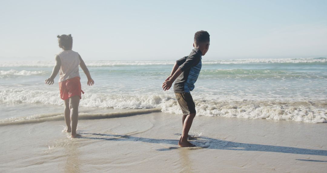 Children Playing in Ocean Waves on Sunny Beach - Free Images, Stock Photos and Pictures on Pikwizard.com