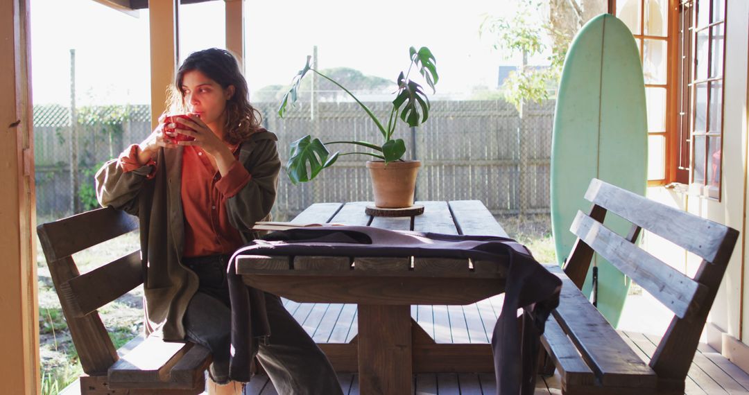 Woman Relaxing on Balcony with Hot Drink - Free Images, Stock Photos and Pictures on Pikwizard.com