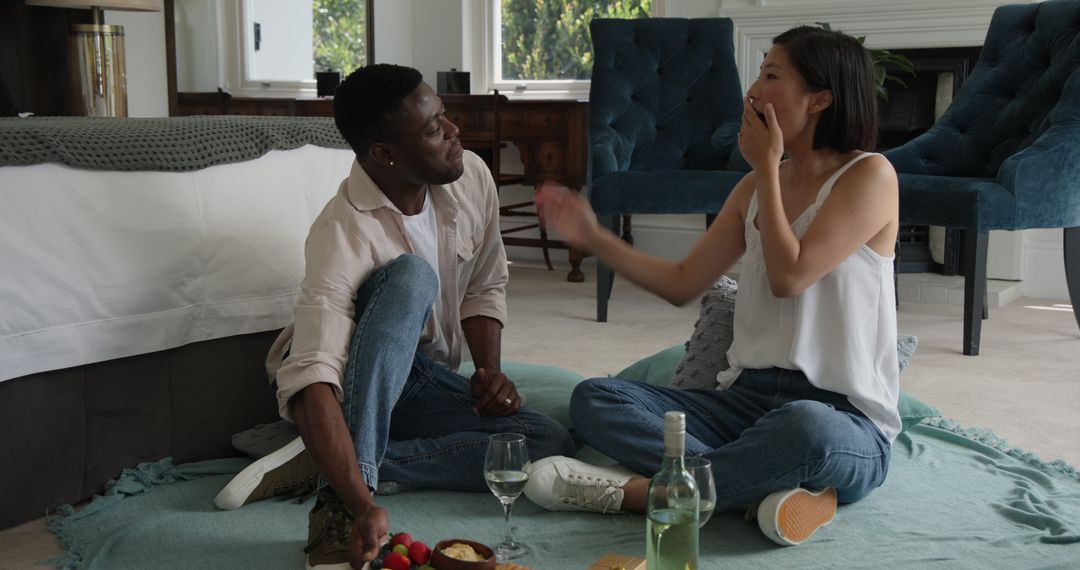 Diverse Couple Relaxing Together in Bedroom with Picnic Setting