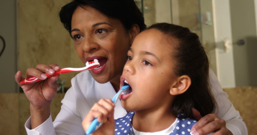 Mother and Daughter Brushing Teeth in Bathroom Together - Free Images, Stock Photos and Pictures on Pikwizard.com