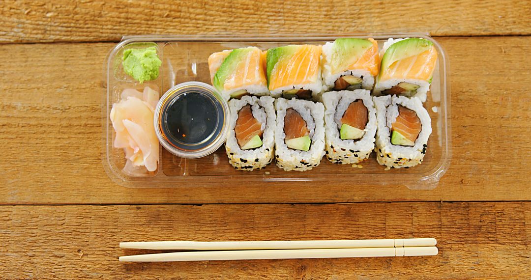 Takeout Sushi Platter on Wooden Table with Soy Sauce and Chopsticks - Free Images, Stock Photos and Pictures on Pikwizard.com