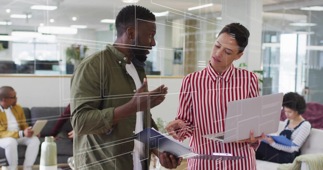 Professionals Discussing Design Schematics in Modern Office