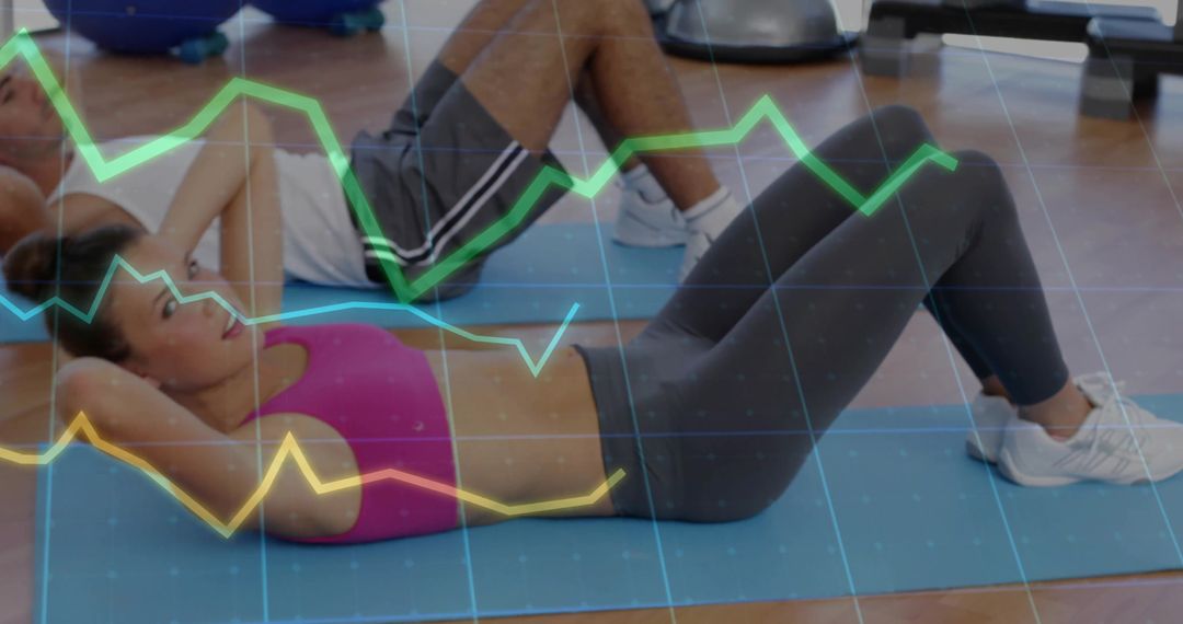 Fitness Duo Doing Crunches With Digital Chart Overlay for Health Tracking