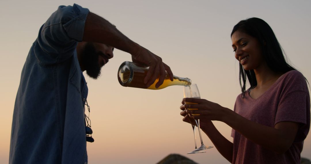 Couple Enjoying Sunset Wine Celebration Outdoors