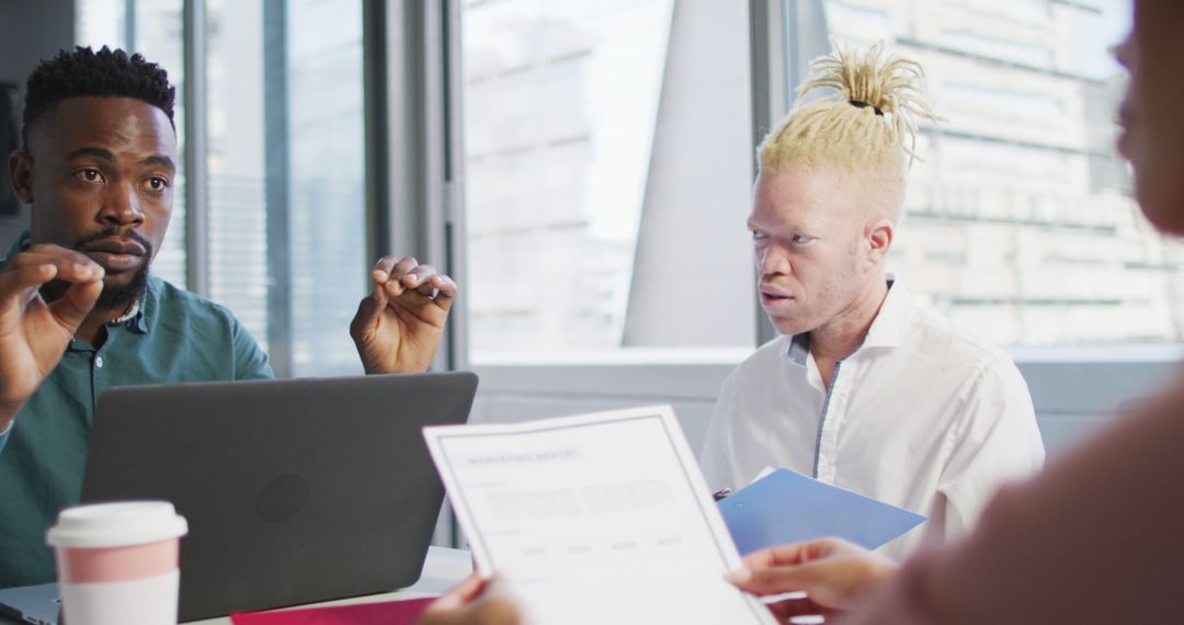 Diverse Team Collaborating on Business Strategies in Modern Office
