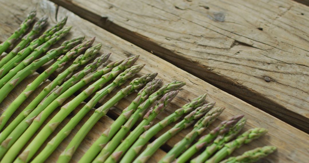 Image of fresh asparagus stalks on wooden background - Free Images, Stock Photos and Pictures on Pikwizard.com