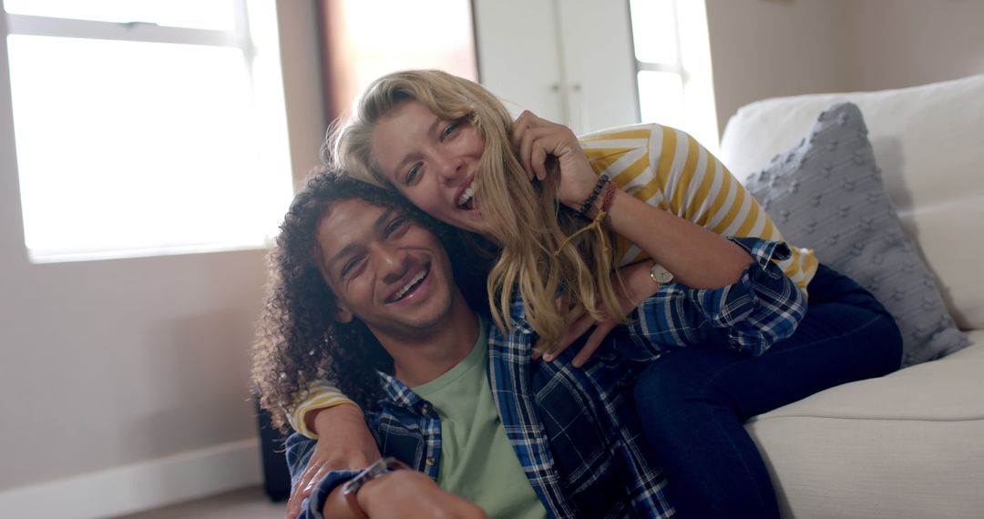 Happy Diverse Couple Laughing and Hugging at Home