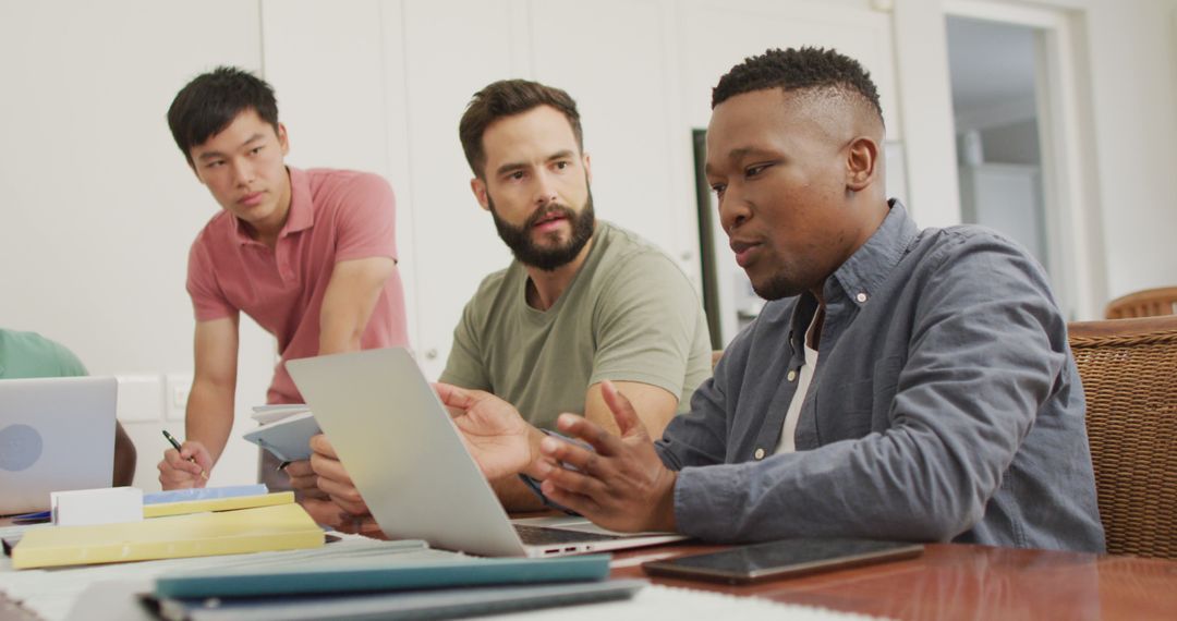 Diverse Friends Collaborating on Project at Home