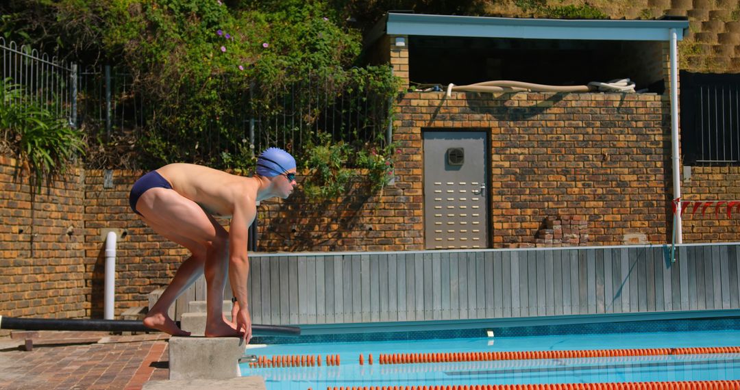 Male Swimmer Preparing to Dive into Outdoor Pool - Free Images, Stock Photos and Pictures on Pikwizard.com