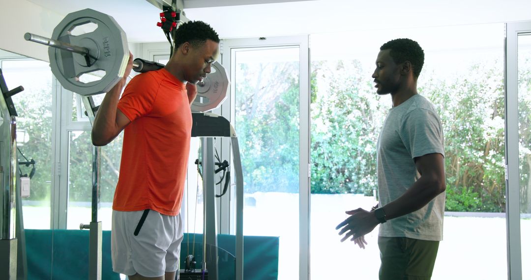 Men Exercising with Barbells in a Home Gym Setting