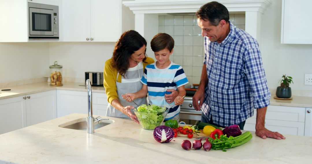 Happy Family Preparing Healthy Salad in Modern Kitchen - Free Images, Stock Photos and Pictures on Pikwizard.com