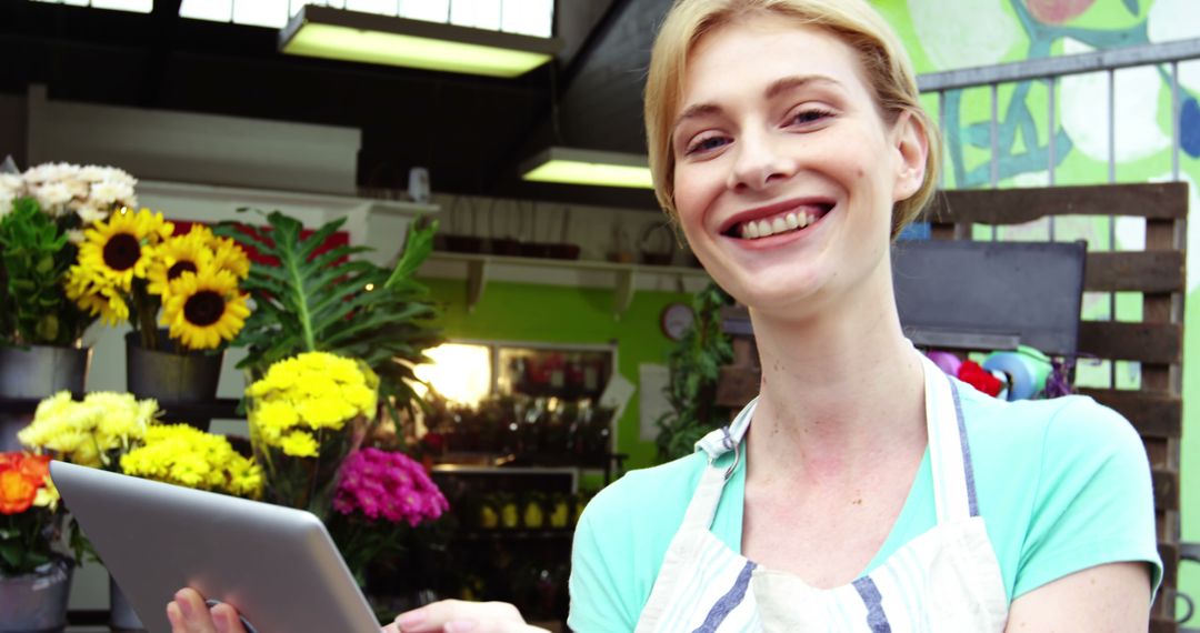 Smiling Female Florist Holding Tablet - Free Images, Stock Photos and Pictures on Pikwizard.com