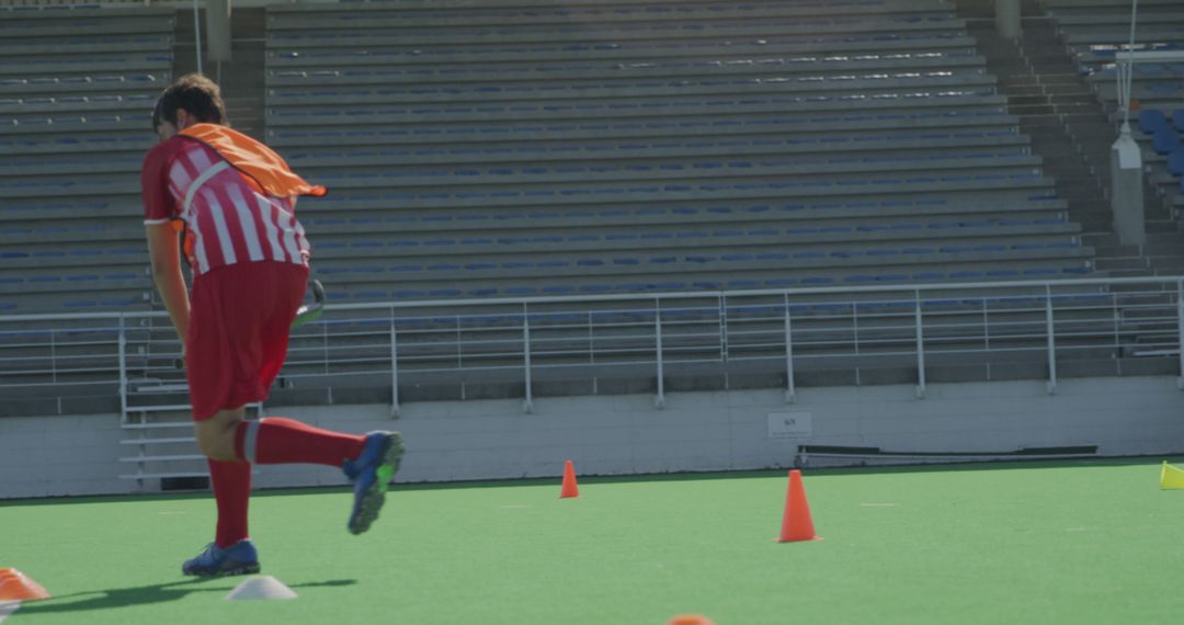 Soccer Player Training on Field with Orange Cones - Free Images, Stock Photos and Pictures on Pikwizard.com