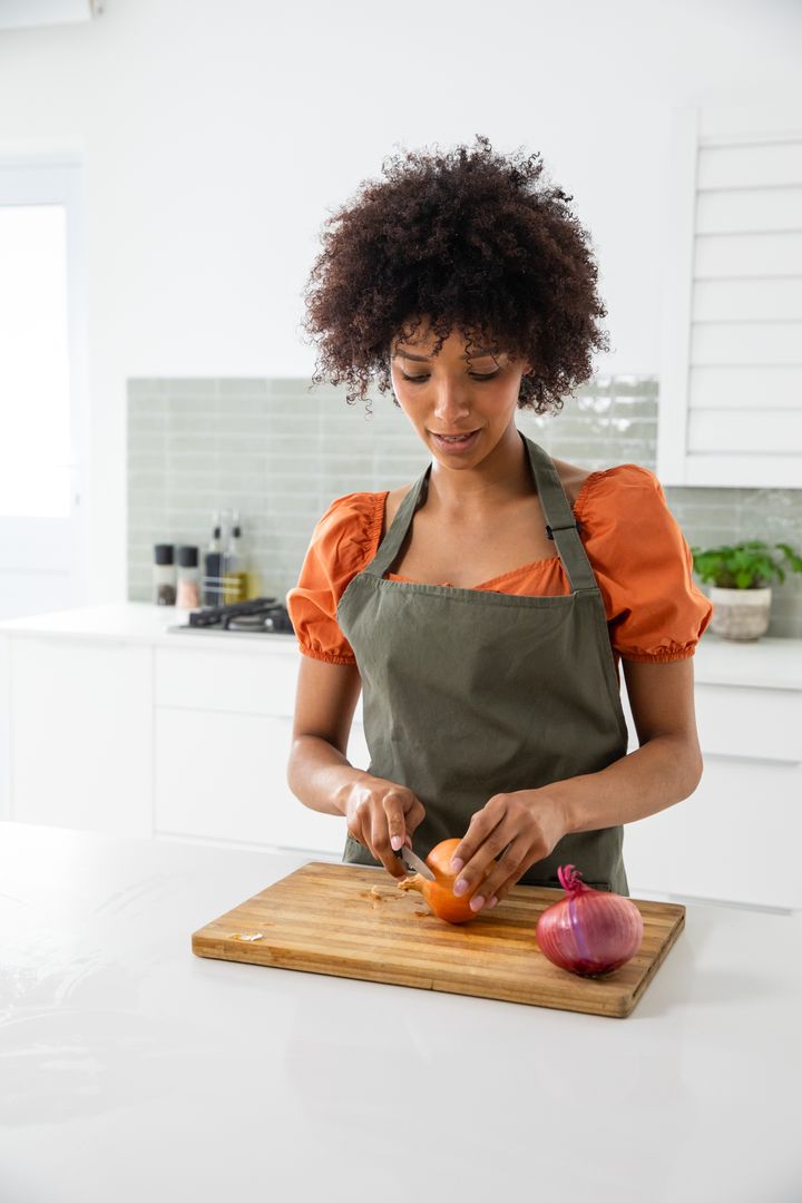 Home Chef Slicing Onion in Bright Modern Kitchen