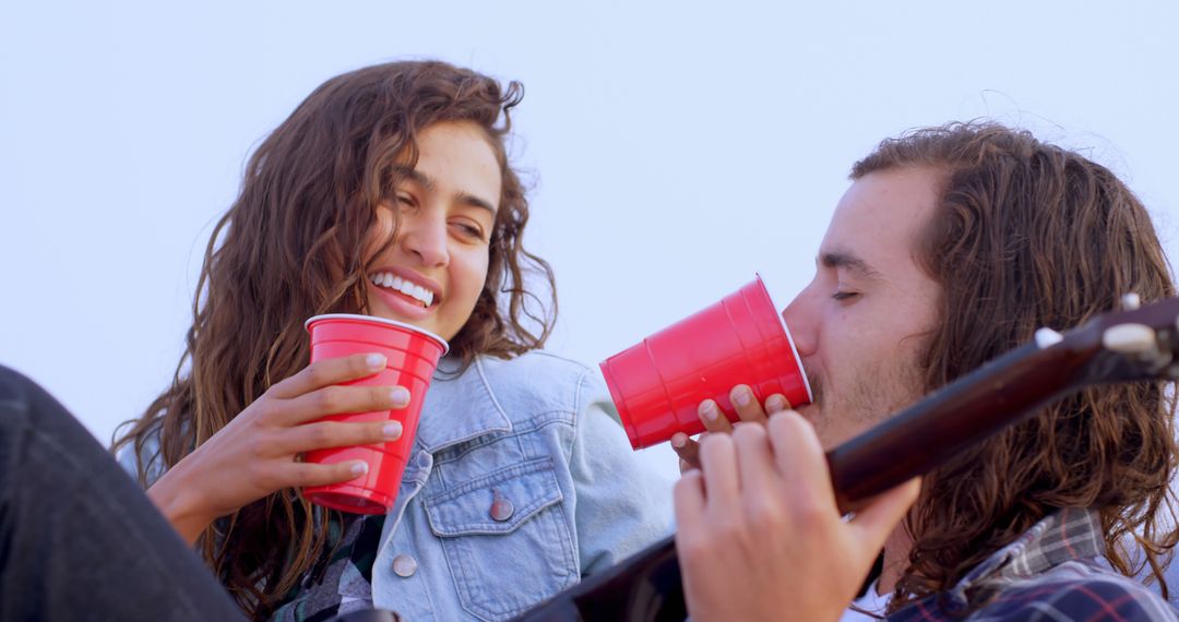 Laughing Friends Drinking Together Outdoors with Red Solo Cups - Free Images, Stock Photos and Pictures on Pikwizard.com