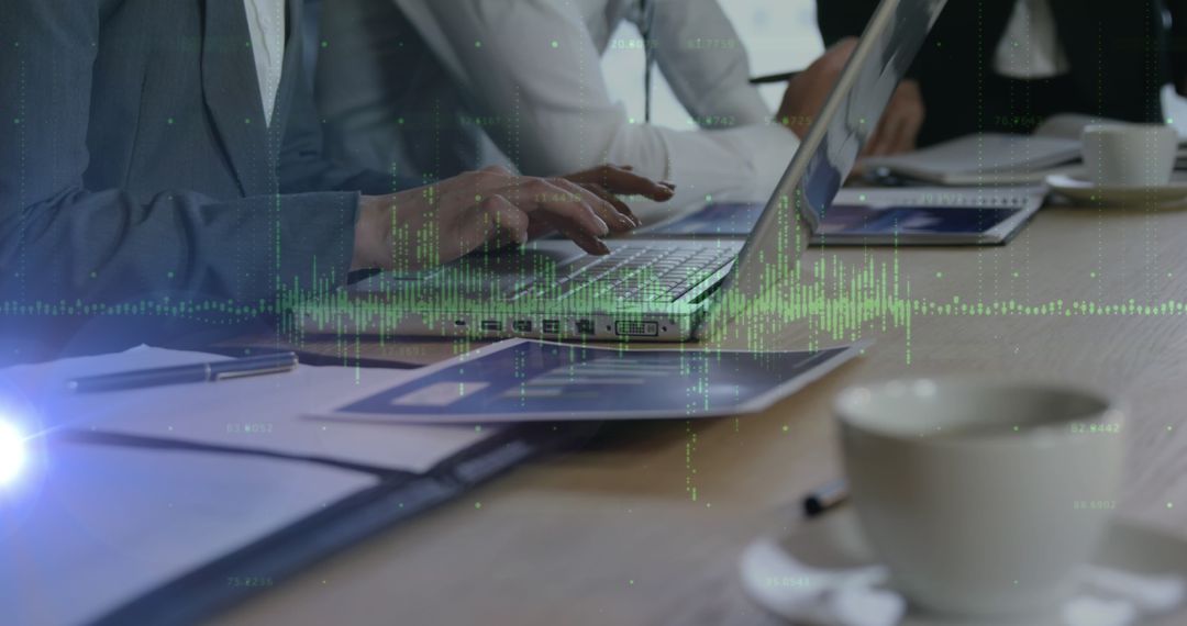 Business Colleagues Analyzing Data on Laptop During Team Meeting