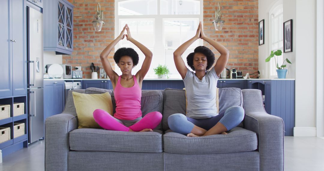 Two African American Women Meditating on Couch at Home - Free Images, Stock Photos and Pictures on Pikwizard.com