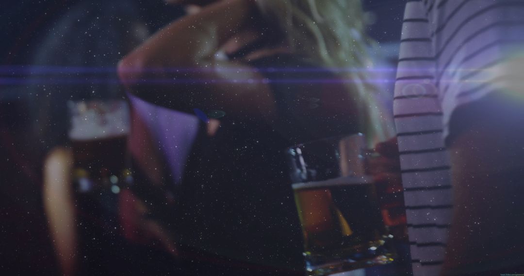 People Socializing at a Bar with Atmospheric Lighting