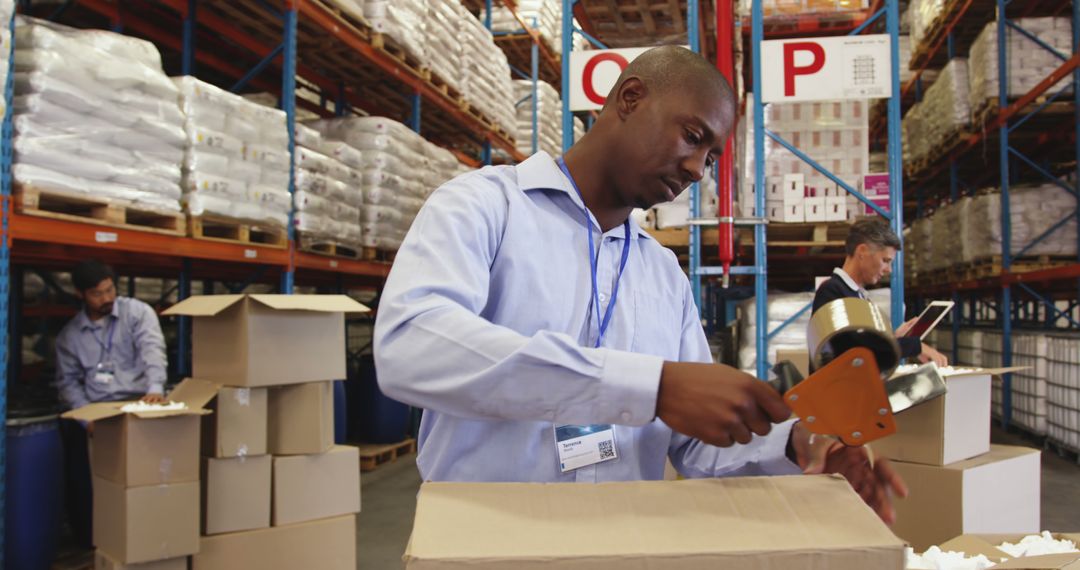 Workers Packing Boxes in Warehouse with Shelves of Inventory - Free Images, Stock Photos and Pictures on Pikwizard.com