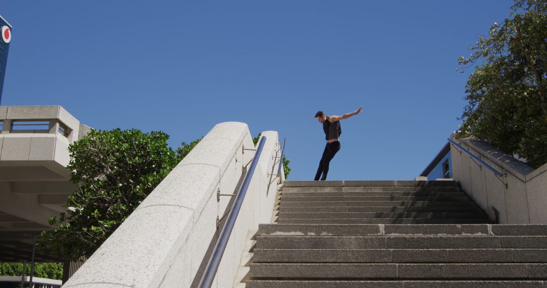 Man Practicing Parkour on Urban Staircase on Sunny Day - Free Images, Stock Photos and Pictures on Pikwizard.com