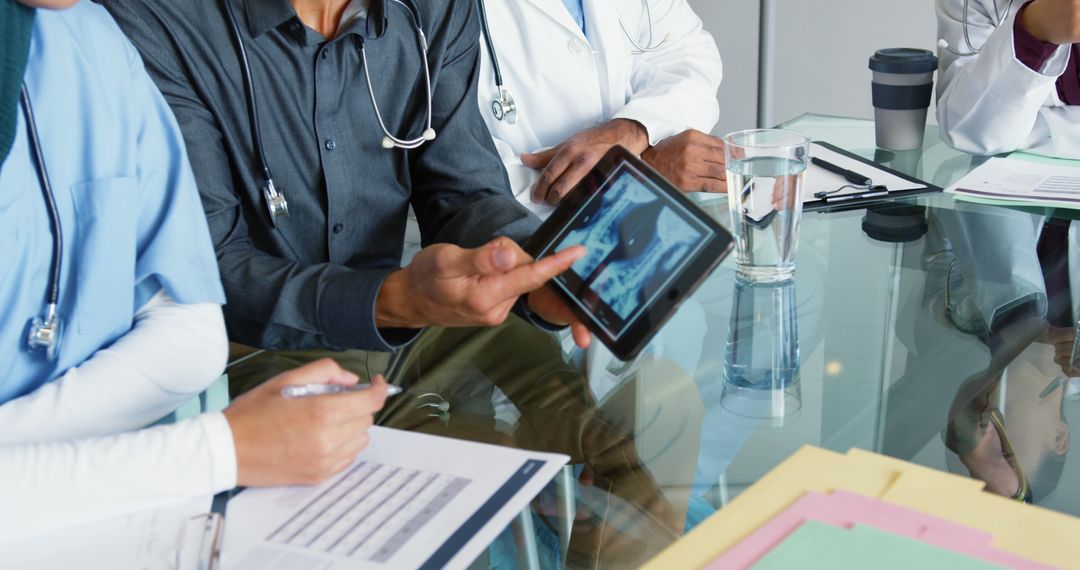 Medical Team Using Digital Tablet Reviewing Patient X-Ray - Free Images, Stock Photos and Pictures on Pikwizard.com