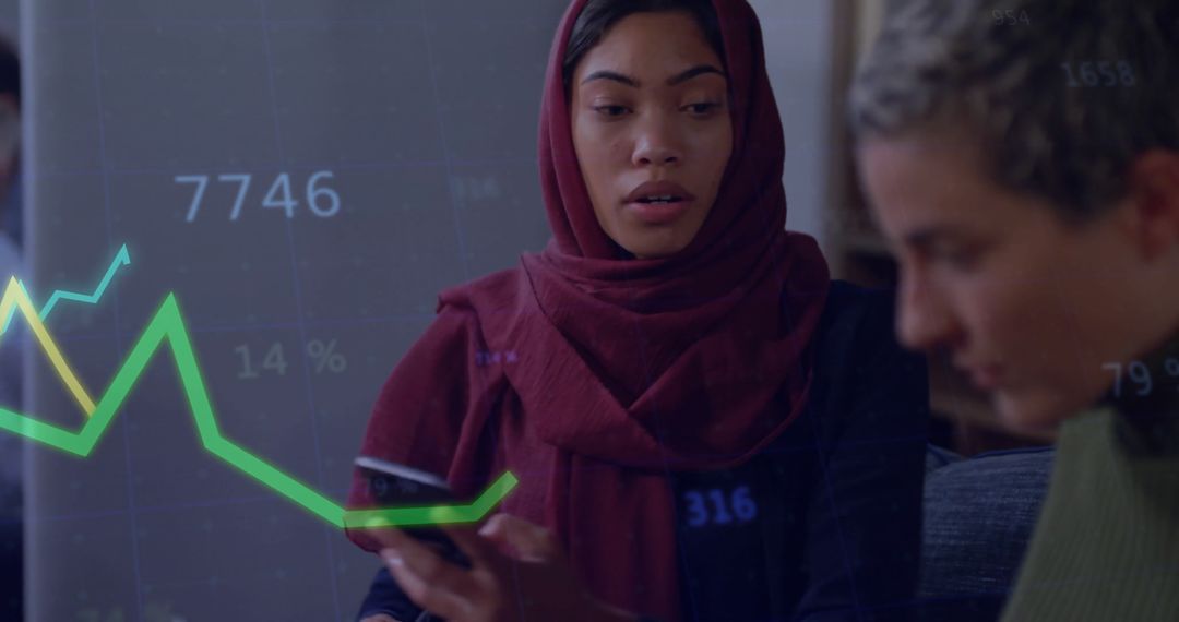 Businesswomen Analyzing Data with Smartphone and Virtual Graphs