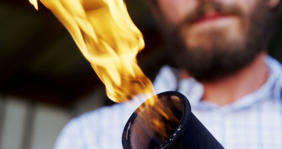 Bearded Man Holding Flame Torch in Outdoor Setting - Free Images, Stock Photos and Pictures on Pikwizard.com