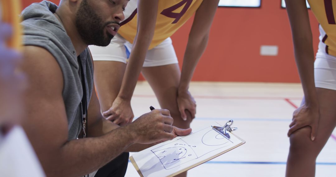 Basketball Coach Strategizing with Players During Practice - Free Images, Stock Photos and Pictures on Pikwizard.com