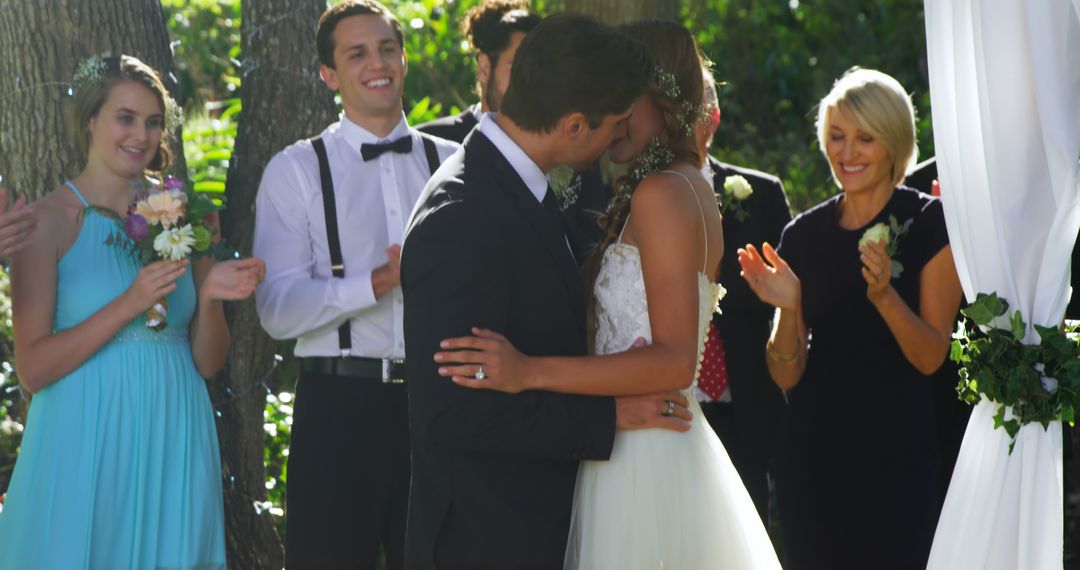 Bride and Groom Sharing First Kiss in Outdoor Wedding Ceremony - Free Images, Stock Photos and Pictures on Pikwizard.com