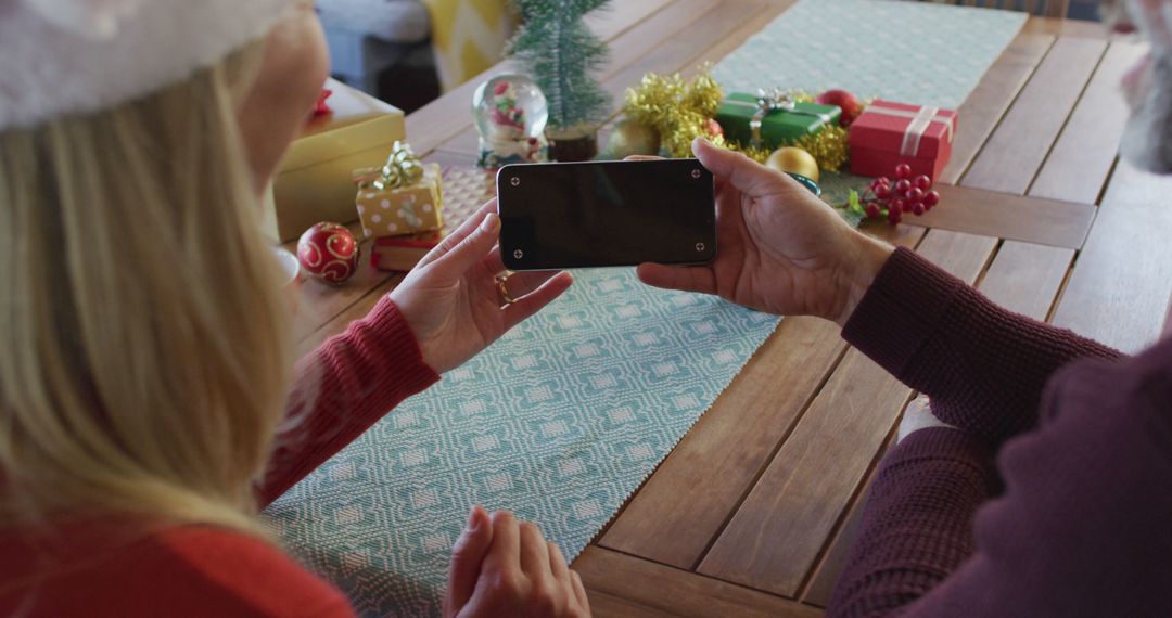 Family Using Smartphone During Christmas Celebration - Free Images, Stock Photos and Pictures on Pikwizard.com