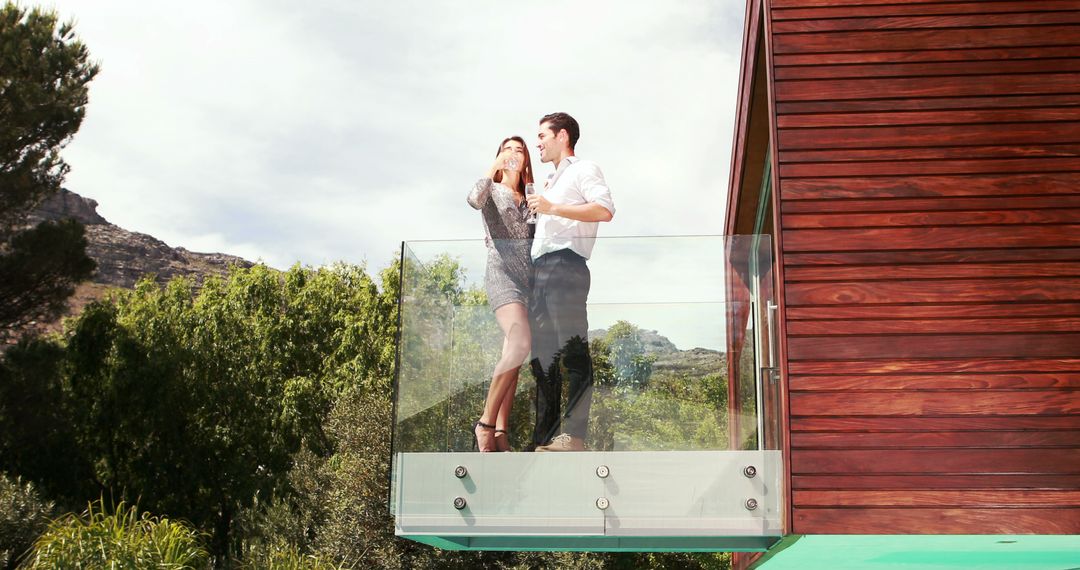 A couple celebrates a special occasion on a scenic balcony in elegant attire. - Free Images, Stock Photos and Pictures on Pikwizard.com