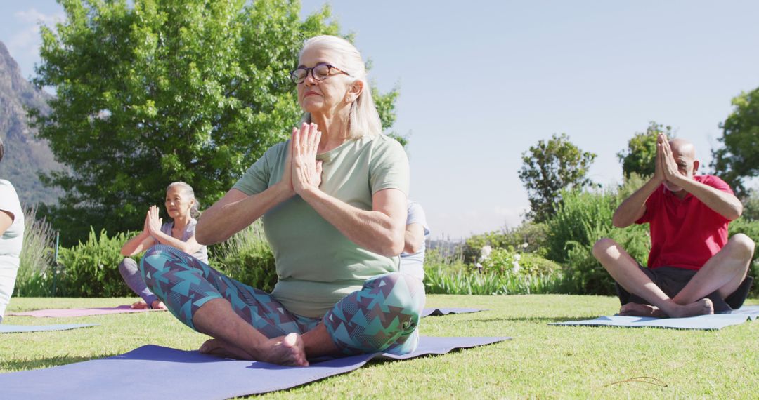 Senior Group Practicing Yoga Meditation Outdoors on Sunny Day - Free Images, Stock Photos and Pictures on Pikwizard.com