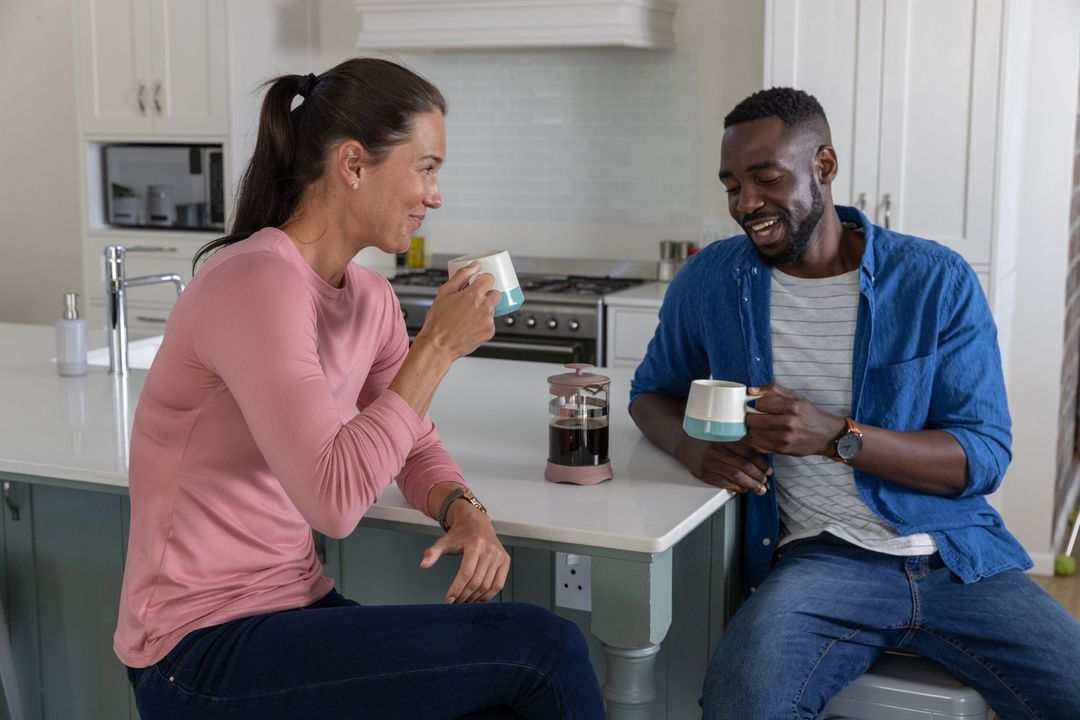 Diverse Couple Enjoying Coffee in Modern Kitchen