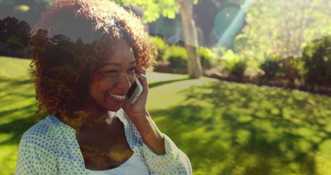 Joyful African American Woman Talking on Phone Outdoors