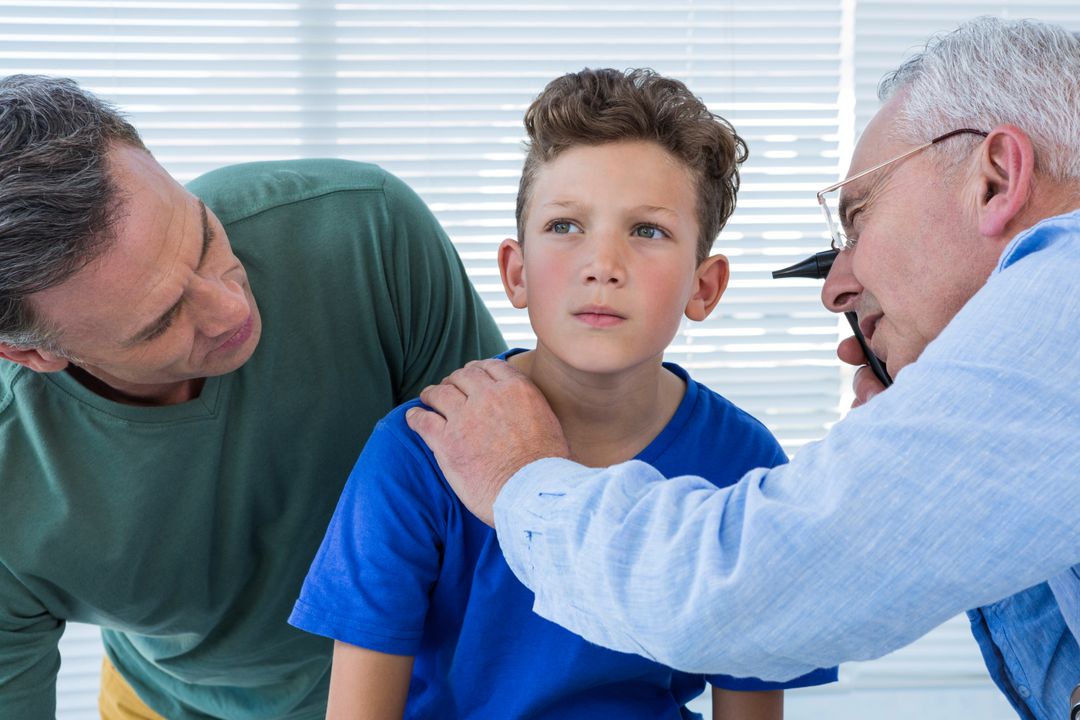 Doctor Examining Boy's Ear with Concerned Parent - Free Images, Stock Photos and Pictures on Pikwizard.com