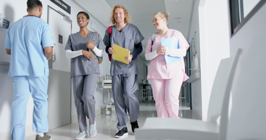 Smiling Medical Students Walking in Hospital Hallway - Free Images, Stock Photos and Pictures on Pikwizard.com