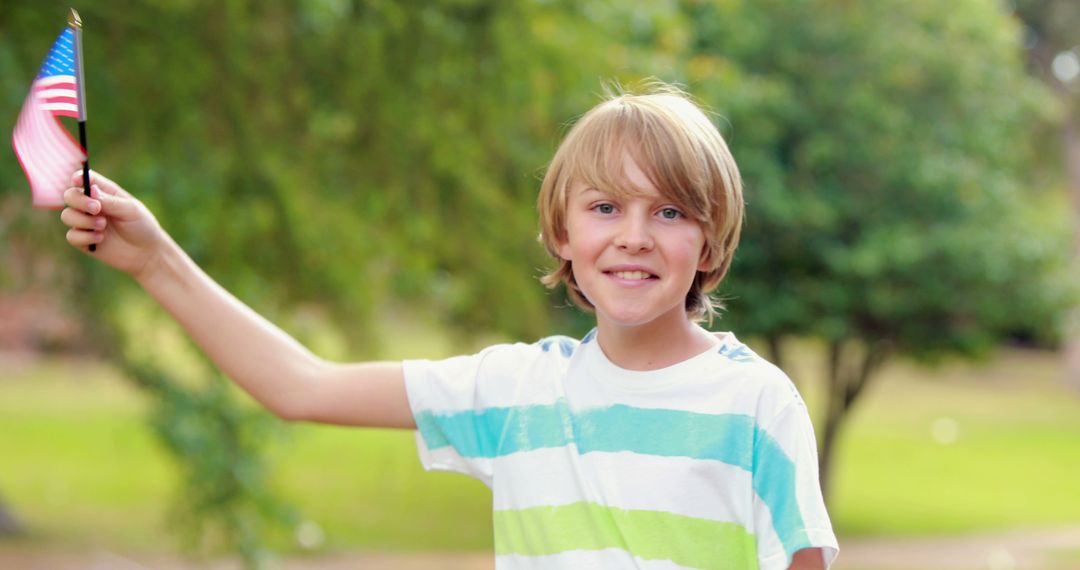 Happy Young Boy Waving American Flag in Park - Free Images, Stock Photos and Pictures on Pikwizard.com