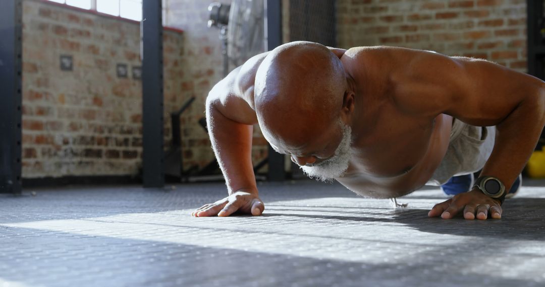 Senior man doing push-ups in urban gym setting - Free Images, Stock Photos and Pictures on Pikwizard.com