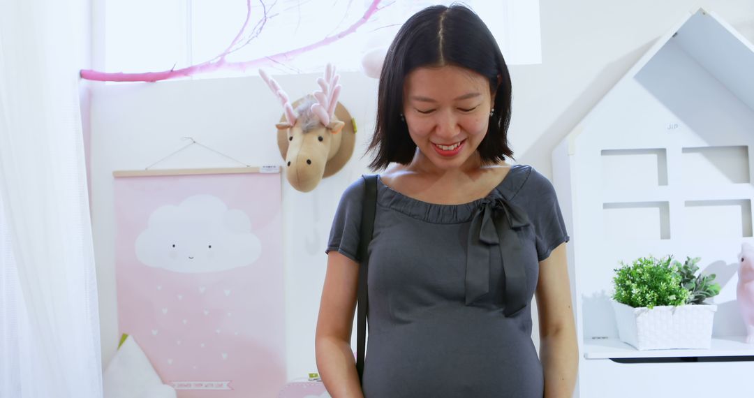 Pregnant Woman Smiling in Nursery Room - Free Images, Stock Photos and Pictures on Pikwizard.com