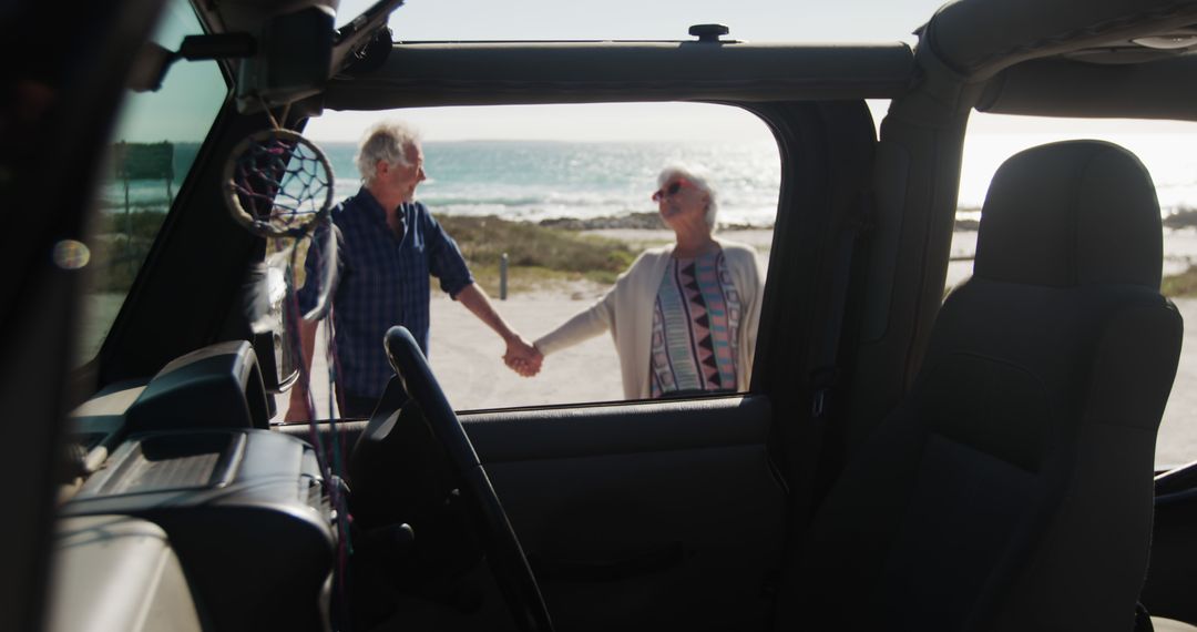 Happy caucasian senior couple holding hands by car on beach by seaside with copy space - Free Images, Stock Photos and Pictures on Pikwizard.com