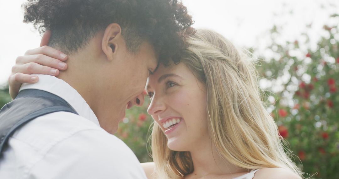 Romantic Young Couple Embracing Outdoors in Blooming Garden