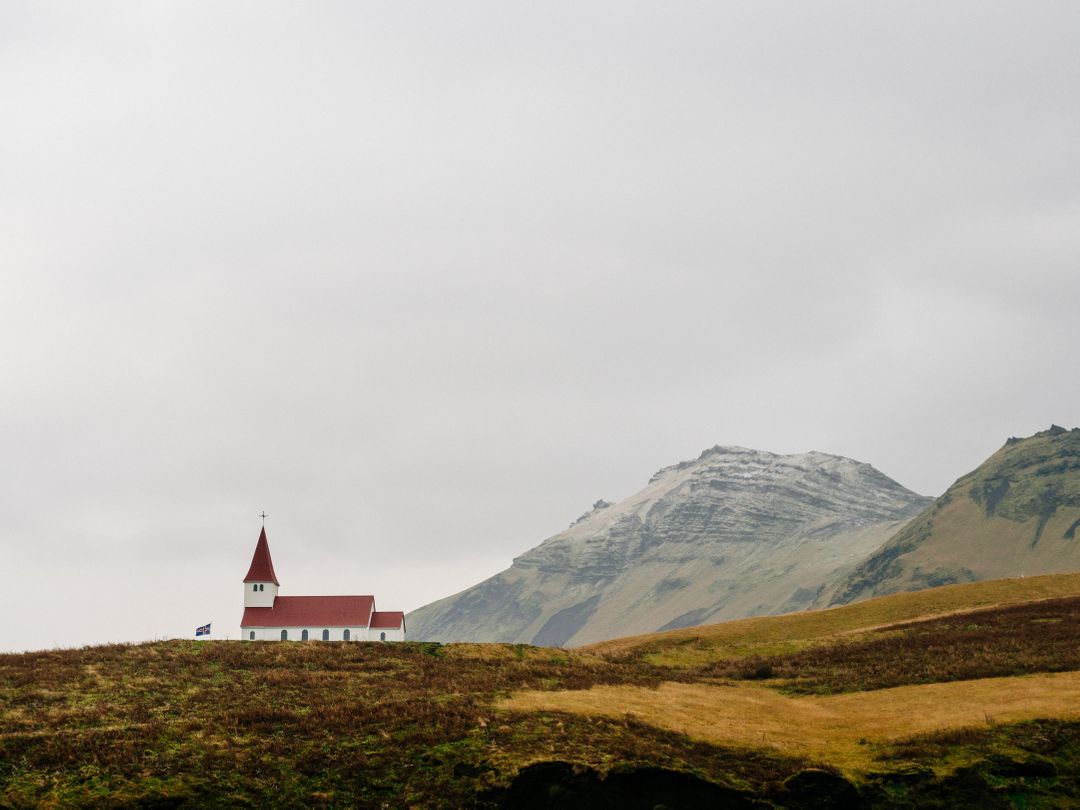 Isolated White Church with Red Roof against Majestic Mountain Landscape - Free Images, Stock Photos and Pictures on Pikwizard.com